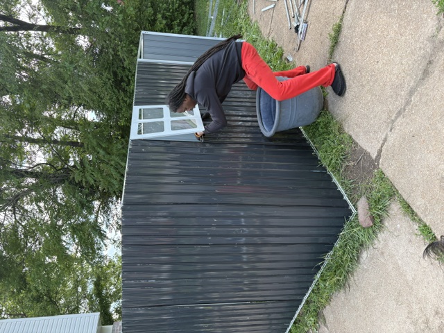 Kahlil building the community shed