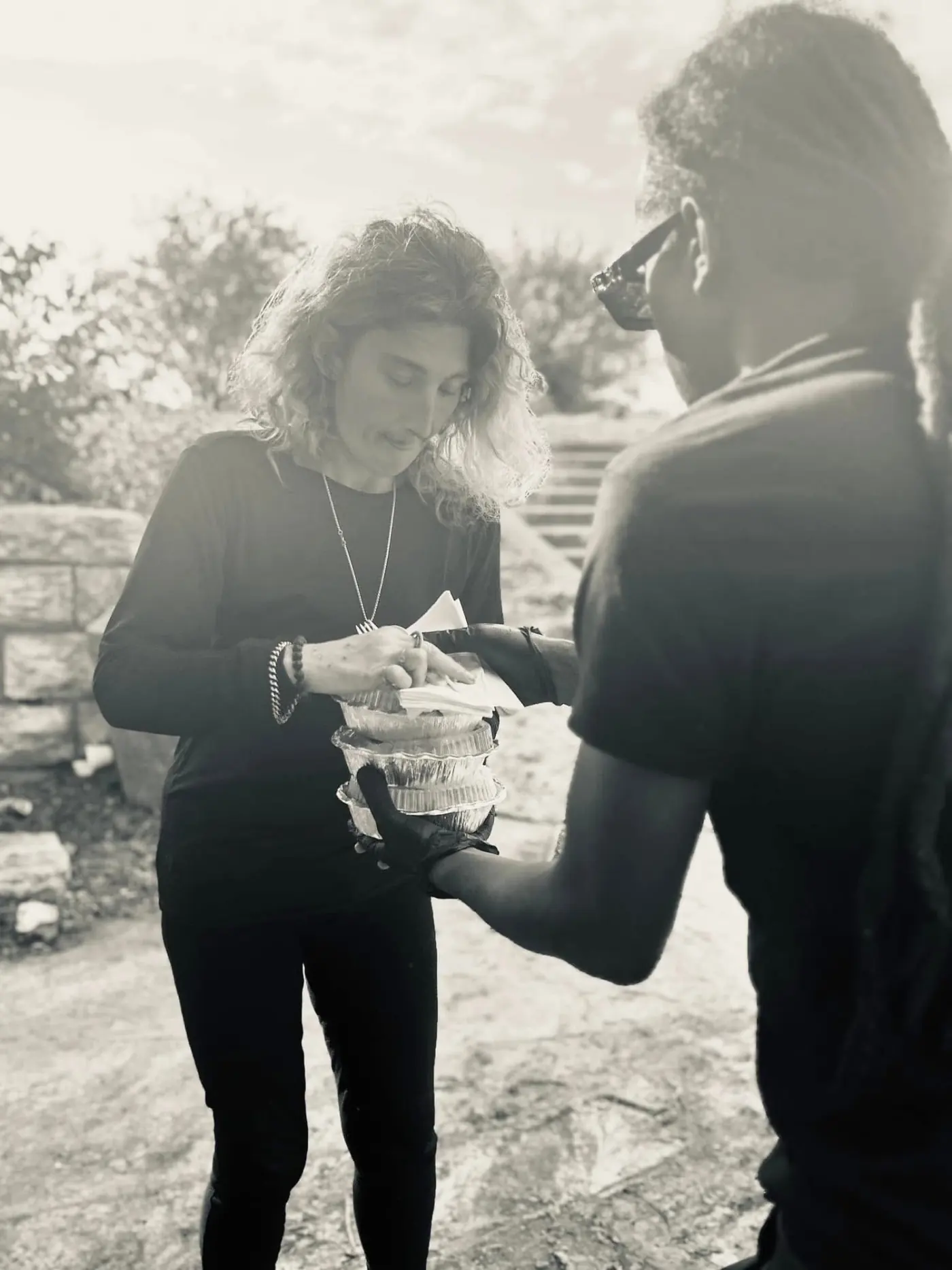 Founder Kahlil Annoor handing out food to an unhoused neighbor downtown